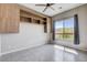 Bedroom features custom built-ins, a ceiling fan, and a view at 10985 Limeslice Ave # 2, Las Vegas, NV 89135