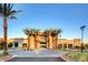 Community clubhouse surrounded by palm trees and well-manicured landscaping at 10985 Limeslice Ave # 2, Las Vegas, NV 89135