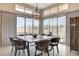 Elegant dining room featuring a modern chandelier and sliding glass doors with scenic views at 10985 Limeslice Ave # 2, Las Vegas, NV 89135