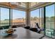 Dining room with sliding glass doors offering scenic desert views and a stylish chandelier at 10985 Limeslice Ave # 2, Las Vegas, NV 89135