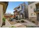 Modern townhome with desert landscaping, paved walkways, and a shared outdoor seating area at 10985 Limeslice Ave # 2, Las Vegas, NV 89135