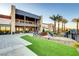 Modern community clubhouse with outdoor seating, a green lawn, and mountain views at 10985 Limeslice Ave # 2, Las Vegas, NV 89135