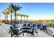 Inviting outdoor fire pit with comfortable seating surrounded by palm trees at 10985 Limeslice Ave # 2, Las Vegas, NV 89135