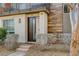 Modern home showcasing a stylish front door, wood accents, and manicured landscaping at 10985 Limeslice Ave # 2, Las Vegas, NV 89135