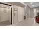 Modern hallway features tiled floors, an elevator and a staircase with white banister at 10985 Limeslice Ave # 2, Las Vegas, NV 89135