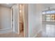 Bright hallway with a view of a half bath and a large living area with tile flooring and contemporary finishes at 10985 Limeslice Ave # 2, Las Vegas, NV 89135