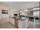 Open-concept kitchen featuring a granite island, sleek appliances, and adjacent living spaces at 10985 Limeslice Ave # 2, Las Vegas, NV 89135
