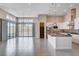 Open-concept kitchen and living area with stainless steel appliances and a large center island at 10985 Limeslice Ave # 2, Las Vegas, NV 89135