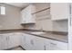 Bright laundry room with white cabinets, gray countertops, and stainless steel fixtures at 10985 Limeslice Ave # 2, Las Vegas, NV 89135