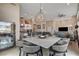 Spacious living area featuring modern decor and large windows, seamlessly connected to the dining space at 10985 Limeslice Ave # 2, Las Vegas, NV 89135