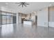 Bright open floor plan featuring tile floors, stainless appliances, kitchen island, and sliding glass doors at 10985 Limeslice Ave # 2, Las Vegas, NV 89135