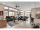 Bright and airy living room with large windows, tile floors, and a modern ceiling fan at 10985 Limeslice Ave # 2, Las Vegas, NV 89135