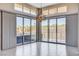 Light-filled living area with sliding glass doors to the outdoor space and decorative hanging light fixture at 10985 Limeslice Ave # 2, Las Vegas, NV 89135