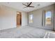 Spacious main bedroom with carpet, large windows, and a doorway leading to the main bathroom at 10985 Limeslice Ave # 2, Las Vegas, NV 89135