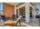 Covered patio features multiple seating arrangements with sliding glass doors opening to the home at 10985 Limeslice Ave # 2, Las Vegas, NV 89135