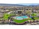 Community pool area with lounge chairs, lush landscaping, and ample space for recreation at 10985 Limeslice Ave # 2, Las Vegas, NV 89135