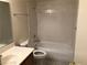 A well-lit bathroom featuring a shower-tub combo with tiled walls at 1105 Sulphur Springs Ln # 102, Las Vegas, NV 89128