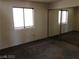 Bedroom showcasing a window with blinds and sliding mirror closet doors at 1105 Sulphur Springs Ln # 102, Las Vegas, NV 89128