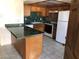 Charming kitchen featuring wood cabinets and a breakfast bar with green marble countertops at 1105 Sulphur Springs Ln # 102, Las Vegas, NV 89128