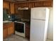 Functional kitchen with wood cabinets, white appliances, and green marble countertops at 1105 Sulphur Springs Ln # 102, Las Vegas, NV 89128