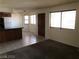 Inviting living room featuring tile flooring, large windows for natural light, and adjacent kitchen area at 1105 Sulphur Springs Ln # 102, Las Vegas, NV 89128