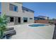 Backyard with pool, lounge chairs, and lush landscaping at 1321 Hudson Creek Pl, North Las Vegas, NV 89084
