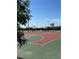 Community basketball court with multiple hoops surrounded by trees and lighting at 1321 Hudson Creek Pl, North Las Vegas, NV 89084