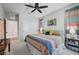 Bright bedroom with a colorful, inviting quilt, neutral carpet and a ceiling fan at 1321 Hudson Creek Pl, North Las Vegas, NV 89084