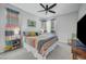 Bright bedroom with a ceiling fan, neutral carpet, and a colorful, inviting quilt and matching curtains at 1321 Hudson Creek Pl, North Las Vegas, NV 89084
