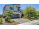 Modern home showcasing a two-car garage, contemporary architecture, and desert-friendly landscaping at 1321 Hudson Creek Pl, North Las Vegas, NV 89084