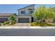 Contemporary two-story home featuring a two-car garage and modern landscaping at 1321 Hudson Creek Pl, North Las Vegas, NV 89084