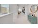 Hallway featuring a cabinet for storage and decor and views of the outside neighborhood at 1321 Hudson Creek Pl, North Las Vegas, NV 89084