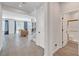 Hallway featuring tile floors, staircase, bathroom, and open floor plan living room at 1321 Hudson Creek Pl, North Las Vegas, NV 89084