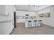 Modern kitchen featuring stainless steel appliances, an island with bar seating, and bright white cabinets at 1321 Hudson Creek Pl, North Las Vegas, NV 89084