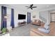 Inviting living room with tile floor, modern fan, and ample natural light at 1321 Hudson Creek Pl, North Las Vegas, NV 89084