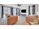 Bright living room with tile flooring, ceiling fan, and neutral paint at 1321 Hudson Creek Pl, North Las Vegas, NV 89084