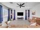 Spacious living room with modern ceiling fan and neutral paint and tile flooring at 1321 Hudson Creek Pl, North Las Vegas, NV 89084