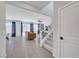 Open-concept living room showcasing tile flooring, staircase, and natural light through windows at 1321 Hudson Creek Pl, North Las Vegas, NV 89084