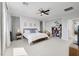 Spacious bedroom with large window, modern decor, and a cozy reading nook with a comfortable armchair at 1321 Hudson Creek Pl, North Las Vegas, NV 89084