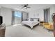 Serene primary bedroom with a large window, comfortable bed, and modern decor for relaxation at 1321 Hudson Creek Pl, North Las Vegas, NV 89084