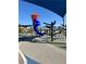 Community playground with a blue spiral slide and climbing structure under shade at 1321 Hudson Creek Pl, North Las Vegas, NV 89084
