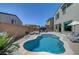 Inviting kidney-shaped pool with a lounging area, surrounded by a brick fence for added privacy at 1321 Hudson Creek Pl, North Las Vegas, NV 89084