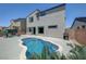 Backyard pool with tanning ledge, outdoor grill, and patio seating at 1321 Hudson Creek Pl, North Las Vegas, NV 89084