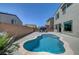 Backyard pool with tanning ledge, landscaping, and patio furniture at 1321 Hudson Creek Pl, North Las Vegas, NV 89084