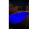 Backyard pool illuminated at night with a view of the neighboring homes at 1321 Hudson Creek Pl, North Las Vegas, NV 89084