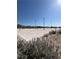 A well-maintained sand volleyball court with nets and lighting for community recreation at 1321 Hudson Creek Pl, North Las Vegas, NV 89084