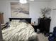 Bedroom with a dark wood bed frame, black dresser, and neutral walls at 1407 Santa Margarita St # A, Las Vegas, NV 89146