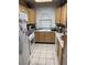 Compact kitchen featuring tile floors, and light wood cabinets at 1407 Santa Margarita St # A, Las Vegas, NV 89146