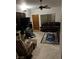 Cozy living room featuring carpet, a ceiling fan, and a comfy leather couch at 1407 Santa Margarita St # A, Las Vegas, NV 89146
