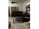 A living room with carpet flooring, leather furniture, and a ceiling fan at 1407 Santa Margarita St # A, Las Vegas, NV 89146